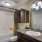 Bathroom has overhead lighting and a large tub